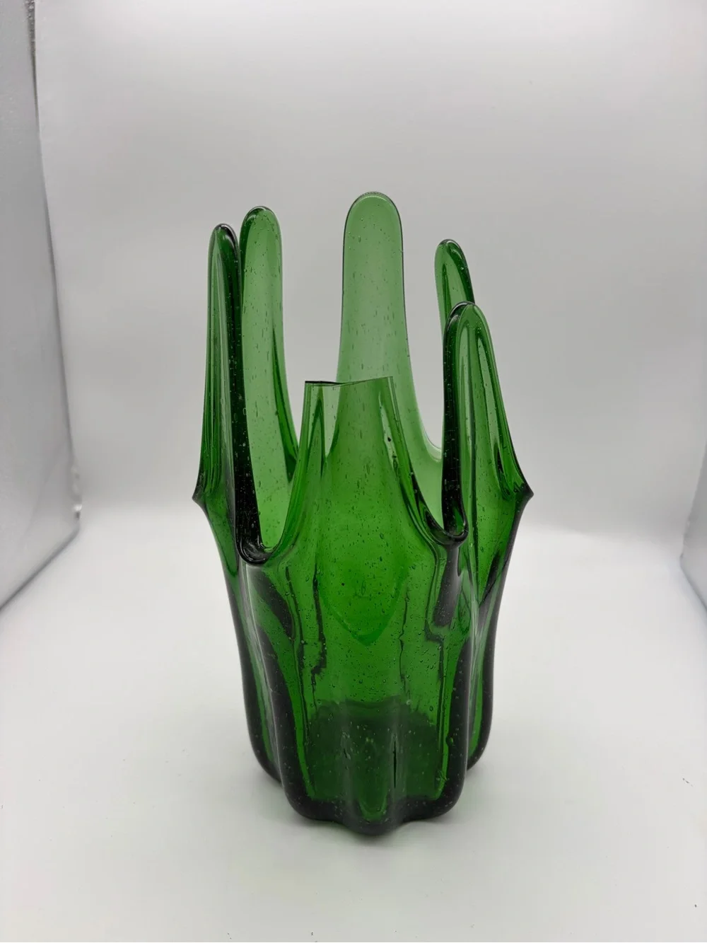Vintage green swing glass vase with purple lily trumpet flowers.